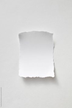 a piece of white paper that has been torn in half