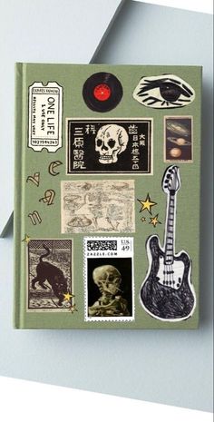 a book with various stickers and pictures on the cover, including an electric guitar