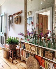 a room filled with lots of books and flowers