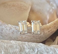 These gorgeous moissanite emerald cut earrings are a total of .60ct. Each stone measures 5x3mm and are D color, VVS clarity. These dainty earrings are perfect for everyday wear. The earrings are available in sterling silver, and 14k white, yellow or rose gold. All items are handmade by me in my shop in Woodbridge, NJ. Please message me with any questions. Shipping within the United States is complimentary. Thank you for exploring my shop! Emerald Cut Earrings, Earrings Emerald, Cut Earrings, Emerald Cut Moissanite, Tiny Studs, Morganite Engagement, Moissanite Earrings, Morganite Engagement Ring, Tiny Stud Earrings