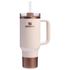 the stanley travel mug is shown with a straw in it