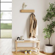 a wooden bench sitting next to a potted plant on top of a hard wood floor