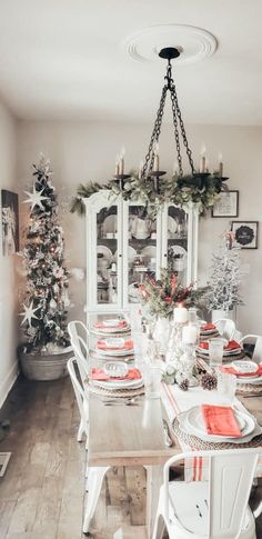 the dining room table is set for christmas dinner