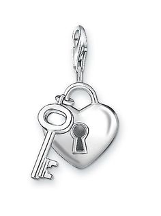 a heart shaped key charm on a white background