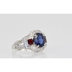 This is part of Chairish’s Fine Jewelry assortment.  Sapphire Ruby Diamond Ring 18K White Gold  This lovely Sapphire Ruby Diamond Ring is set in 14K White Gold. It features a Oval cut Sapphire weighing in at 2.67 Carats, flanked by 2 Rubys square cut and weighing 0.70 carats and White Diamonds, F-G, VS weighting in at 2.50 Carats. Set in a square shank mounting, measuring approximately 15mm tapering to 2.4mm Size 6.5. Total weight: 5.87 carats. I purchased this to go with many of my Tutti Frutti Formal Sapphire Ring With Cushion Diamond Cut, Formal Sapphire Ring With Cushion Cut, Classic Multi-stone Princess Cut Rings, Classic Princess Cut Multi-stone Rings, Luxury Multi-stone Sapphire Baguette Cut Ring, Formal Sapphire Ring With Princess Cut And Accent Stones, Fine Jewelry Multi-stone Sapphire Ring In 14k White Gold, Luxury Cushion Cut Multi-stone Jewelry, Formal Multi-stone Cubic Zirconia Birthstone Ring