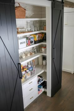 a pantry with sliding doors and shelves filled with food