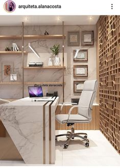 an office desk with a laptop computer on it in front of a book shelf and shelving