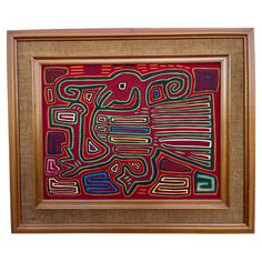 an abstract painting with different colors and shapes in a wooden frame on a white background