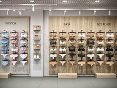 two rows of bras on display in front of wooden shelves