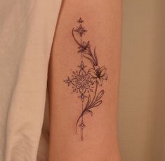 a woman's arm with a flower tattoo on the left side of her body