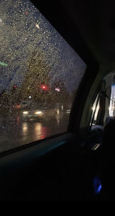 rain is falling on the windshield of a car