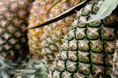 many pineapples are stacked on top of each other