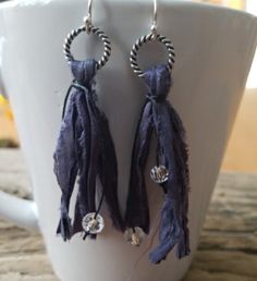 "Be on trend with our uniquely yours beaded tassel earrings! We've started with different colors of vintage ribbon, and repurposed it into our own handmade tassels--your choice of navy blue, emerald green, or khaki (one with a silver ring and the other with a copper ring). The tassels are made hanging from a nickel free ring (see your choices) and then tied with small crystal czech glass beads to give you a little bling. The drop on these earrings varies between 2.5\" and 3\", so they are not to Elegant Blue Tassel Earrings For Festival, Trendy Dangle Tassel Earrings For Festivals, Trendy Tassel Dangle Earrings For Festival, Trendy Adjustable Tassel Earrings As Gift, Trendy Adjustable Tassel Jewelry, Trendy Blue Fringe Jewelry, Fringe Drop Tassel Earrings As Gift, Fringe Tassel Drop Earrings As Gift, Bohemian Tassel Earrings With Ear Wire For Party