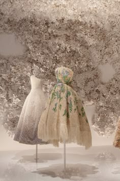 three mannequins dressed in different colored dresses