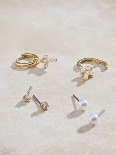 Elevate your everyday style with this delicate 18k gold dipped earring pack. The minimalist mini hoop with a cross, the classic pearl stud, and the sparkling cubic zirconia stud offer endless styling possibilities. A perfect blend of modern and traditional. Earring Pack, Beaded Bow, Bracelet Pack, Bow Bracelet, Jewelry Accessories Ideas, Pearl Earring, Gold Dipped, Accessories Ideas, Accessories Jewelry Earrings