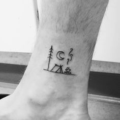 a man's foot with a small tattoo on the ankle that says go camping