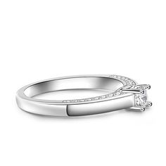 Simple and stunning, this ring showcases a magnificent round cut stone standing tall in the traditional four-prong setting, while additional round stones line the shank. So elegant it needs no further accompaniment, this ring is finished with a bright polished shine. The stones in this engagement ring shine brightly enough to be deserving as a symbol of your love.Carat Weight: 0.275 ctStone Size: 4 mmStone Type: Jeulia® StoneNumber of Stones: 1 Stone Color: Diamond WhiteStone Shape: RoundCarat Weight: 0.648 ctStone Size: 1.1,1.3,1.5 mmStone Type: Jeulia® StoneNumber of Stones: 32 Stone Color: Diamond WhiteStone Shape: RoundWeight: 2.7 gWidth: 1.7 mmHeight: 4.9 mmThickness: 1.2 mmMaterial: 925 SilverPlating Color: Silver Moissanite Channel Set Round Cut Ring, Channel Set Princess Cut Rings, Diamond White Diamond Ring With Prong Setting For Promise, White Gold Crystal Ring With Diamond Accents For Promise, Solitaire Open Band Promise Ring Jewelry, Elegant Adjustable Crystal Ring In Diamond White, Elegant Adjustable Diamond White Crystal Ring, Silver Timeless Promise Ring, Timeless Silver Promise Ring