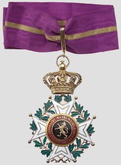 an award medal with a purple ribbon around it and a gold crown on the top