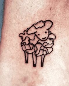 a small sheep tattoo on the ankle