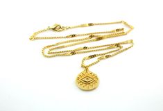 A rich golden eye has been crafted on a medallion and set on sturdy twinkling golden chains to create this gorgeous enchanting necklace, perfectly suited for layering. This open eye symbol is found across many cultures, bringing the bearer luck and protection. The 15x16mm 24k gold plated eye charm rests on 1.5x2mm 24k gold plated curb chains that have been flattened at even intervals to create a wavy starburst effect. This necklace is finished with a 24k gold plated lobster claw clasp. This neck Gold Medallion Necklace With Evil Eye, Gold Chain Necklace With Evil Eye As Gift, Gold Chain Necklace With Evil Eye For Gift, Evil Necklace, Crescent Moon Necklace Gold, Luck Necklace, Eye Of Providence, Star And Moon Necklace, Gold Moon Necklace