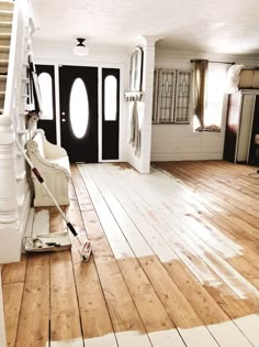 an empty room with hard wood flooring and white paint on the walls is being cleaned