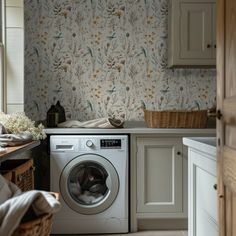 a washer and dryer in a room with floral wallpaper on the walls