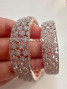 Rose gold  Finish American Diamond/CZ Bangles/Bracelet/Indian Party Wear Bangles/ CZ stone bangles/Indian wedding/bridal jewelry Plating-Rose gold  Opening :secures with a magnetic snap and hinge closure It is made by our artisans using expert techniques, so it sparkles and shines over the years. Best gift option for your loved ones comes in an exquisite gift box. Dazzling Sparkling Bangle As Gift, Dazzling Sparkling Bangle For Gift, Sparkling Diamond Bangle As Gift, Sparkling Diamond Bangle Gift, Dazzling Rose Gold Wedding Bracelets, Diamond Sparkling Bangle For Anniversary, Rose Gold Cubic Zirconia Bangle, Dazzling Rose Gold Bling Jewelry, Hand Set Rose Gold Bangle