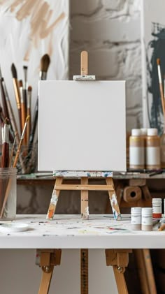 an artist's easel with paint and brushes on it