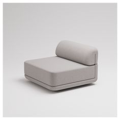 a white couch sitting on top of a gray floor