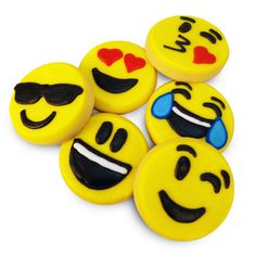 some yellow and black decorated cookies with smiley faces on top of each cookie, one has a red heart in the other's eyes