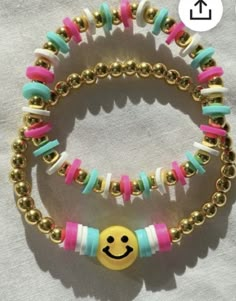 two bracelets with different colored beads and a smiley face beaded on the clasp