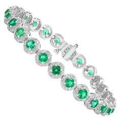 Add color to your style with this gorgeous Emerald bracelet. Features 26 Round cut Emeralds surrounded by a single row of sparkling round diamonds in a halo setting. Emeralds and diamonds weigh 5.88 carats and 1.43 carats total respectively. Made in 14 karat white gold. All diamonds are GH color SI1 Clarity. Available in Ruby and Emerald as well. Style available in different price ranges. Prices are based on your selection. Please contact us for more information. Luxury Diamond Bracelet With Halo Setting, Luxury Tennis Bracelet With Halo Setting For Formal Events, Luxury Tennis Bracelet With Halo Setting For Formal Occasions, Luxury Diamond Bracelet With Halo Setting For Formal Events, Luxury Diamond Bracelet With Halo Setting For Formal Occasions, Luxury Diamond Bracelets With Halo Setting, Luxury Formal Bracelet With Halo Setting, Luxury Formal Bracelets With Halo Setting, Fine Jewelry Tennis Bracelet With Halo Setting For Anniversary