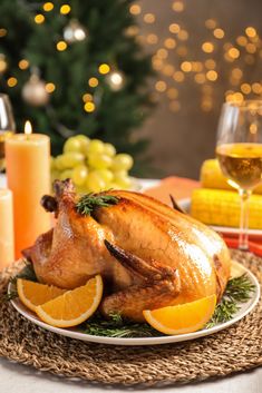 a roasted turkey on a plate with oranges and wine