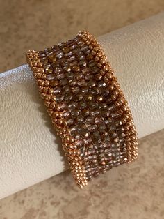 This is a one of kind, Czech fine polish cuff handcrafted with a copper slide clasp. Elegant Brown Cuff Bracelet As Gift, Elegant Brown Cuff Bracelet Gift, Unique Gold Beaded Cuff Bracelet, Handmade Rose Gold Copper Cuff Bracelet, Handmade Elegant Bronze Beaded Bracelets, Elegant Handmade Copper Bracelets, Elegant Copper Bracelet As A Gift, Elegant Copper Cuff Jewelry, Elegant Copper Cuff Bracelet