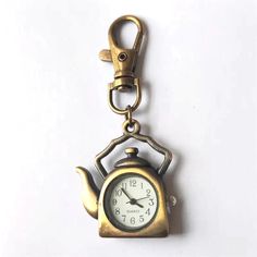 Introducing our Teapot Shape Pocket Watch Creative Bronze Keychain – the perfect fusion of vintage charm and modern functionality! This exquisite keychain is not just a timepiece; it's a statement accessory that adds character to your style while keeping you punctual. Crafted with precision, this Novelty Quartz Watch is designed in the shape of a teapot, evoking a sense of nostalgia and whimsy. The intricate bronze detailing gives it a timeless appeal, making it a versatile accessory suitable fo Car Keychain, Elegant Gift, Accessories Unique, Pandora Charms, Vintage Charms, Quartz Movement, Quartz Watch, Pocket Watch, Lovely Gift