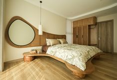 a large bed sitting on top of a hard wood floor next to a wooden dresser