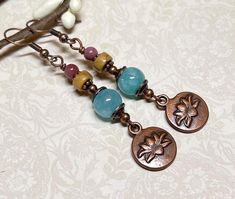 Everyday boho style dangle earrings created using blue Quartzite stone beads, Picasso Jasper heishi gemstone beads, small round Mookaite Jasper beads, copper accents, and antique copper lotus flower charms. Total length of earrings, including the ear wire, is approximately 2-1/2".  The bronze lotus flower charms measure approximately 1/2" x 1/2". Thank you for shopping with The Lucie Collection! Bohemian Drop Earrings With Gemstone Beads, Bohemian Gemstone Beads Earrings, Bohemian Teardrop Gemstone Bead Earrings, Bohemian Gemstone Beaded Earrings As Gift, Wrapped Chandelier, Blue Quartzite, Earthy Jewelry, Diy Jewelry Ideas, Mookaite Jasper