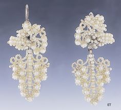 Presented is a lovely pair of Victorian seed pearl bridal earrings. These pieces date to around the 1850-1870 and are of American make. The earrings have 10 karat gold backs, for pierced ears. The earrings consist of seed pearls with larger round pearls sewn onto a mother-of-pearl backing, forming a design of a cluster of grapes. Seed pearl jewelry in this delicate, hand-sewn style was often made and worn specifically as bridal jewelry for a wedding, and this suite would be a lovely addition to Antique Wedding Earrings With Historical Design, Victorian Style Pearl Earrings For Evening, Victorian Baroque Earrings For Formal Occasions, Victorian Baroque Earrings, Victorian Style White Earrings For Formal Occasions, White Victorian Earrings For Formal Occasions, Victorian Style Formal Pearl Drop Earrings, Victorian Pearl Earrings For Anniversary, Ornate Historical Wedding Earrings