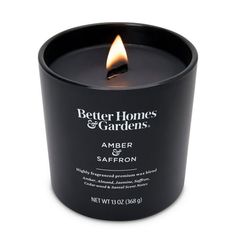 a black candle that is sitting in front of a white background with the words better homes and gardens on it