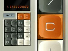 an orange and black calculator sitting on top of a white table next to another calculator