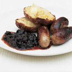 a white plate topped with potatoes and raisins