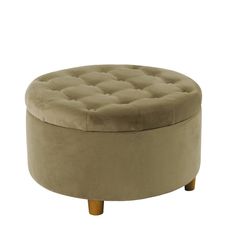 a round ottoman with wooden legs and a buttoned up seat on the bottom, in beige