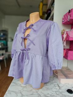 This upcycled handmade blouse is made from men's shirts that could have turned into waste, giving them a second life. The blouse is decorated with charming ruffles, tied with laces, pastel purple tones are easily combined with jeans or classic trousers Puffed Sleeves Blouse, Tie Up Blouse, Handmade Blouse, Classic Trousers, Upcycled Clothes, Purple Tones, Sleeves Blouse, Purple Top, Pastel Purple