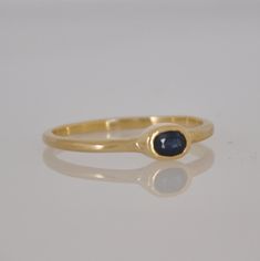 "This is a 18k gold Beautiful ring with a gentle oval blue Sapphire gemstone. That soliter ring is just the perfect stacking ring. Not too big and not too small. You can wear this ring every day and for every occasion. The blue Sapphire color is a perfect harmony with the 18k solid gold. This ring can be the center piece of a set of gold stacking rings. I can set diffrent color of gemstone in this gold ring. Dimensions: Oval Sapphire: 5 m\"m * 3 m\"m You can see other gemstone rings n my shop: h Oval Sapphire Ring In 14k Gold With Polished Finish, Elegant Sapphire Signet Ring, Elegant Sapphire Ring In Recycled Gold, Elegant Yellow Gold Sapphire Ring With Recycled Metal, Elegant Sapphire Ring With Recycled Gold, Heirloom Sapphire Ring With Bezel Setting As Gift, 14k Gold Oval Sapphire Ring Hallmarked, Sapphire Ring With Recycled Gold For Wedding, Classic Stackable Sapphire Rings In Yellow Gold