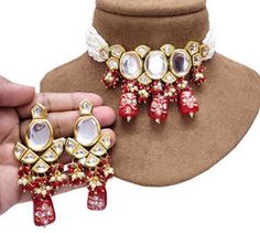 Gold Rodium Polish Red and Maroon color Necklace in Metal Alloy studded with Kundan Pendant Jewelry Sets For Parties And Festivals, Red Party Jewelry For Festive Season, Red Kundan Necklace For Festive Party, Red Kundan Necklace For Party And Festive Season, Red Jewelry For Festival Party, Elegant Red Choker For Festivals, Red Jeweled Jewelry For Celebration, Red Jeweled Metal Necklaces, Red Metal Jewelry Sets For Party