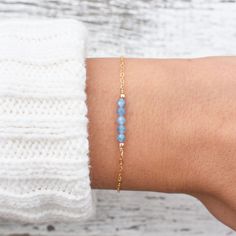 "This hand made bracelet showcases a stunning selection of blue topaz rondelles, centered on a dainty but durable chain in your preferred finish. This makes a wonderful gift for someone with a December birthday. Bracelet Size Guide: Petite: 6.5\"-7\" Average (fits most wrists): 7-8\" Large: 8-8.5\" Adjustable: 6.5\" bracelet with attached 1.5\" extender chain To find your bracelet size, simply measure the circumference of your wrist by wrapping a string around it and measuring the length of the Delicate Blue Bracelets For Everyday, Minimalist Everyday Blue Topaz Jewelry, Minimalist Blue Bracelet With Delicate Chain, Everyday Blue Bracelet With Adjustable Chain, Blue Adjustable Chain Bracelet For Everyday, Dainty Blue Gemstone Beaded Bracelets, Blue Dainty Gemstone Beaded Bracelet, Dainty Blue Faceted Beaded Bracelets, Blue Dainty Crystal Bracelet Gift