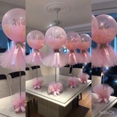 balloons with pink bows and name on them are hanging from the ceiling in front of a dining room table