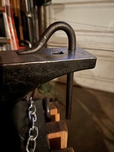 a metal hook is attached to a chain on a workbench in a shop