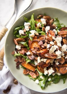 a salad with nuts and feta cheese on top is shown in an instagram post