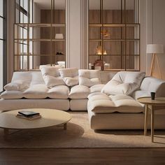 a living room filled with lots of white furniture